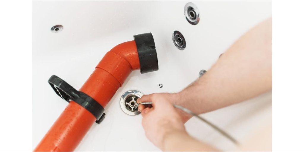How should I use a drain snake properly
